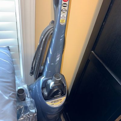 Sale Photo Thumbnail #272: Blue Kenmore upright vacuum cleaner with attached power cord and controls along the handle.