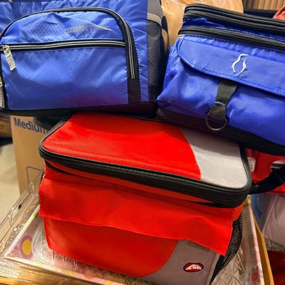 Sale Photo Thumbnail #274: Three soft-sided insulated cooler bags, including a blue Ozark Trail model, a smaller blue bag, and a red and grey cooler bag, all in gently used condition.