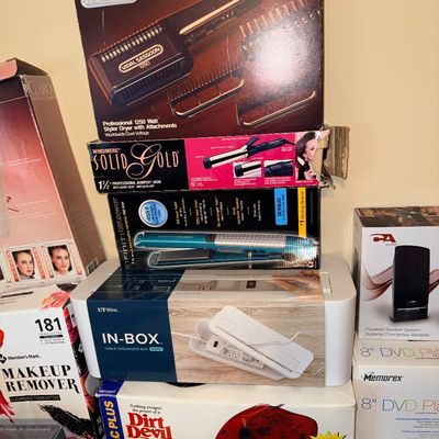Sale Photo Thumbnail #294: Collection of boxed vintage and modern personal care electronics and household items, including hair styling tools and a Dirt Devil handheld vacuum.