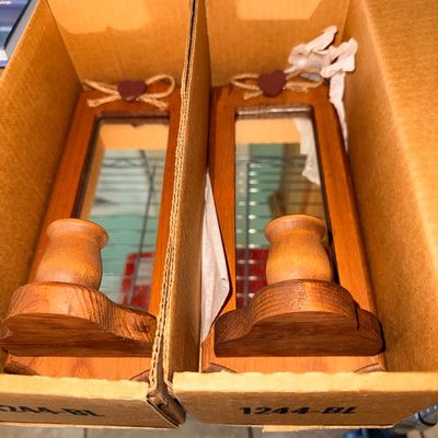 Sale Photo Thumbnail #323: Pair of vintage rustic wooden wall sconces with rectangular mirrors, candle holders, and heart accents, packed in cardboard boxes.