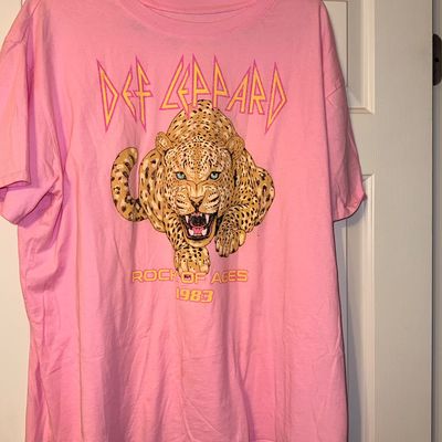 Sale Photo Thumbnail #325: Pink Def Leppard graphic t-shirt featuring a leopard illustration and "Rock of Ages 1983" lettering, hanging on a door.
