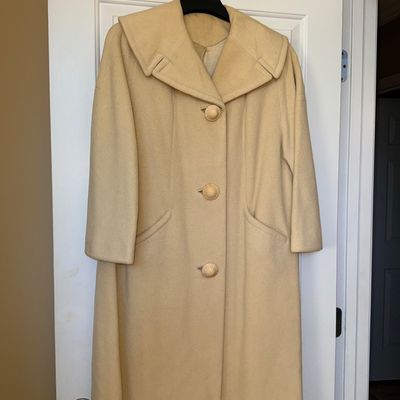 Sale Photo Thumbnail #337: Vintage 1950s light yellow wool coat featuring a prominent wide collar, large textured buttons, and side slash pockets.