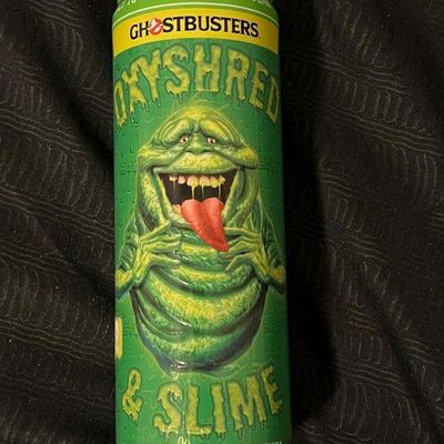 OxyShred Ghostbusters Slimer-themed energy drink can, featuring a green design with the Slimer character.