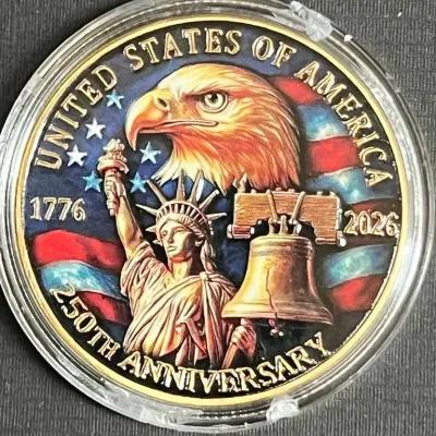 United States of America 250th Anniversary commemorative coin, dated 1776-2026, featuring a colorized design with an eagle, the Statue of...