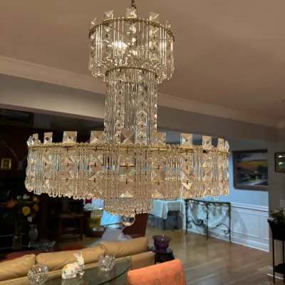 Sale Photo Thumbnail #3: Multi-tier vintage crystal glass and brass chandelier featuring layered prism drops and a central glass column.