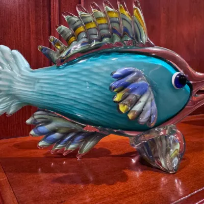 Sale Photo Thumbnail #45: Murano style blown art glass fish figurine featuring vibrant turquoise, blue, and yellow casing with detailed fins.
