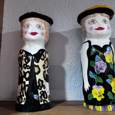 Sale Photo Thumbnail #50: Pair of vintage hand-painted ceramic lady vases or statues, featuring bold patterns including leopard print and colorful floral designs.
