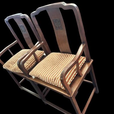Sale Photo Thumbnail #78: 42.75"T  29" arm ht  20.5" seat ht  23" seat width Solid hardwood construction featuring curved yoke top crests  back splats carved with character medallion longevity symbols  slatted armrests  box stretcher bases  and removable striped seat cushions Chin