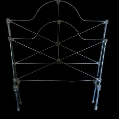 Sale Photo Thumbnail #86: Vintage dark iron twin bed frame. Includes arched headboard featuring high-back headboard with carved crest scrollwork  horizontal wood paneling  and matching carved footboa  Footboard with cross-bracing  plus side rails. Shows age and some surface wear. 