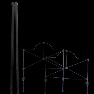 Sale Photo Thumbnail #84: Vintage dark iron twin bed frame. Includes arched headboard featuring high-back headboard with carved crest scrollwork  horizontal wood paneling  and matching carved footboa  Footboard with cross-bracing  plus side rails. Shows age and some surface wear. 