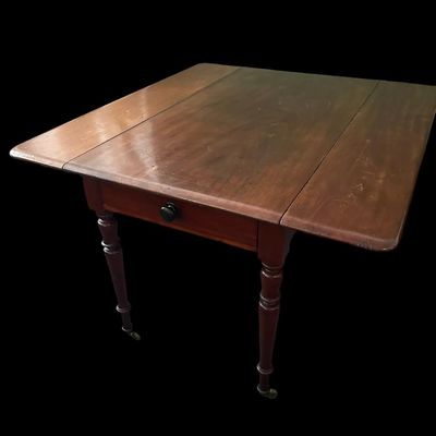 Sale Photo Thumbnail #124: 42"W (leaves) / 24"W (no leaves) × 45"L × 29"T Vintage Solid Wood Drop-Leaf Dining Table  features two fold-down end leaves and tapered legs and silverware drawer. Measurements: 42" wide w/leaves  24" w/o leaves  45" length  29" tall. Local  .  