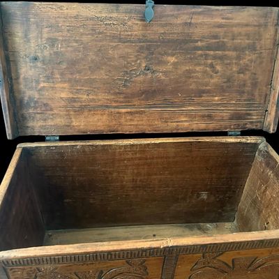 Sale Photo Thumbnail #139: 24"W × 11"D × 16"H Antique-style solid wood chest featuring deep relief-carved front panels with double-headed peacock motifs  stippled background  carved border trim  dark iron latch hardware  hinged top lid  and turned ball feet. Dimensions: 24" Wide 