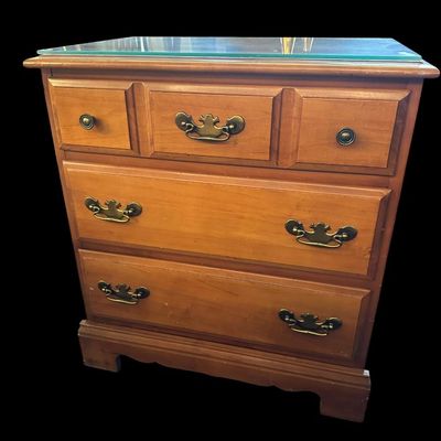 Sale Photo Thumbnail #220: 26"T × 24"W × 15"D Solid wood nightstand/chest featuring glass top cover  3 storage drawers with brass bail pulls  and bracket feet. Dimensions: 26" Tall x 24" Wide x 15" Deep.  