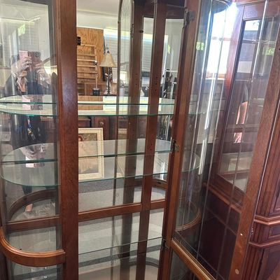 Sale Photo Thumbnail #471: 86"T × 44"W × 15"D Tall wood-framed curio cabinet with curved glass sides and arched top. Lighted interior with 5 glass shelves. Measurements: approx. 86" tall × 44" wide × 15" deep. Great for displaying collectibles. Local   in   / Shreveport area.  
