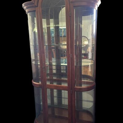 Sale Photo Thumbnail #468: 86"T × 44"W × 15"D Tall wood-framed curio cabinet with curved glass sides and arched top. Lighted interior with 5 glass shelves. Measurements: approx. 86" tall × 44" wide × 15" deep. Great for displaying collectibles. Local   in   / Shreveport area.  