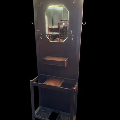 Sale Photo Thumbnail #485: 72 X 28 X 9.50 Central octagonal beveled mirror  upper double hat/coat hooks  small center glove box with hinged lid  umbrella/cane storage rails with removable metal drip pans at base. Retains original gold foil "Lawrencia" maker's trade mark label. 72 X