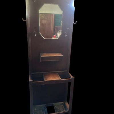 Sale Photo Thumbnail #481: 72 X 28 X 9.50 Central octagonal beveled mirror  upper double hat/coat hooks  small center glove box with hinged lid  umbrella/cane storage rails with removable metal drip pans at base. Retains original gold foil "Lawrencia" maker's trade mark label. 72 X