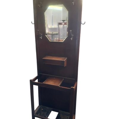 Sale Photo Thumbnail #480: 72 X 28 X 9.50 Central octagonal beveled mirror  upper double hat/coat hooks  small center glove box with hinged lid  umbrella/cane storage rails with removable metal drip pans at base. Retains original gold foil "Lawrencia" maker's trade mark label. 72 X