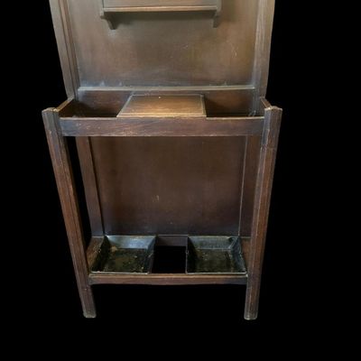 Sale Photo Thumbnail #482: 72 X 28 X 9.50 Central octagonal beveled mirror  upper double hat/coat hooks  small center glove box with hinged lid  umbrella/cane storage rails with removable metal drip pans at base. Retains original gold foil "Lawrencia" maker's trade mark label. 72 X