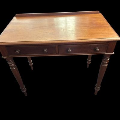 Sale Photo Thumbnail #498: 31 X 23 X 48 Antique Colonial Style Walnut 2-Drawer Writing Desk  features low back gallery guard rail  2 drawers with wooden turn knobs  turned spindle legs  and solid wood construction with light surface age patina.  