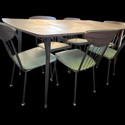 Sale Photo Thumbnail #579: 29.50 Tall 70.50 Long (w/leaves) 46.00 (w/o leaves) 35.50 Wide 11.50 (each leaf) MCM dining set featuring walnut-tone laminate rectangular table with extension leaf and tapered black metal legs with brass ferrule feet  paired with 6 matching chairs featur