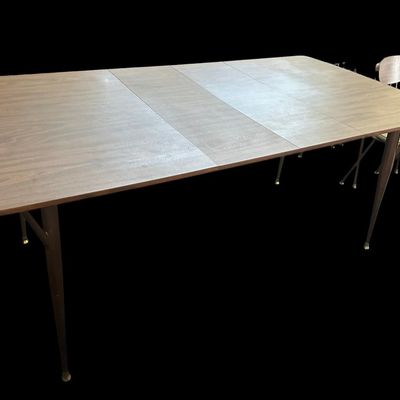 Sale Photo Thumbnail #586: 29.50 Tall 70.50 Long (w/leaves) 46.00 (w/o leaves) 35.50 Wide 11.50 (each leaf) MCM dining set featuring walnut-tone laminate rectangular table with extension leaf and tapered black metal legs with brass ferrule feet  paired with 6 matching chairs featur