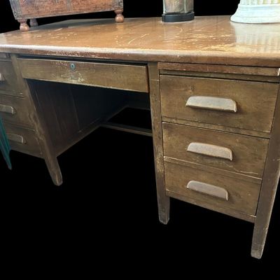 Sale Photo Thumbnail #628: 60"W × 34"D × 30"H Heavy-duty solid wood office desk featuring 6 side storage drawers with carved integrated wood pulls  central locking pencil drawer  and spacious working surface with character wear and age patina. Dimensions: 60" Wide x 34" Deep x 30