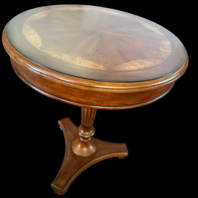 Sale Photo Thumbnail #779: 28.50 Tall 23.00 Round Round accent table featuring an intricate starburst grain wood inlay with burl veneer border top under glass  fluted center pedestal  and tripod splayed base. Dimensions: 36" Round x 17.50" Tall.  