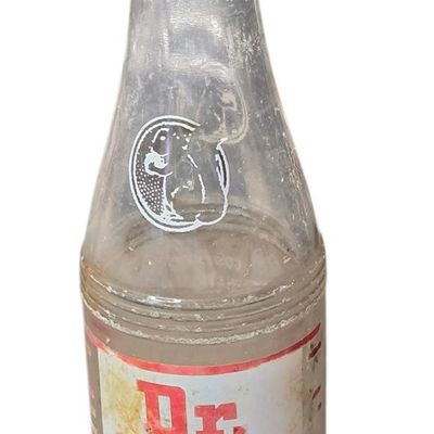 Sale Photo Thumbnail #795:  Dr. Nut 7 oz New Orleans regional soda bottle. Label damaged.                           