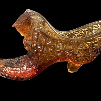 Sale Photo Thumbnail #888:  Amber pressed-glass slipper with cat on the heel. Fenton-style novelty. Check ear for chips.                           