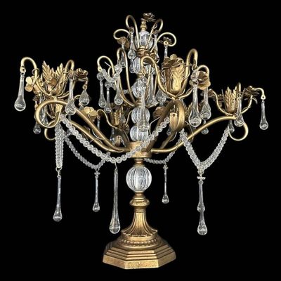 Sale Photo Thumbnail #914: Vintage Hollywood Regency style decorative tabletop centerpiece (epergne style) in an antique gold gilt finish. Features a central fluted glass urn column supporting sweeping scrolled brass arms adorned with dimensional carved brass rose blooms and foliag