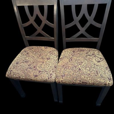 Sale Photo Thumbnail #916: Pair of contemporary side dining chairs with ebony wood frames  intersecting curved backrest splats  and rich woven brown/gold paisley tapestry seat cushions.  