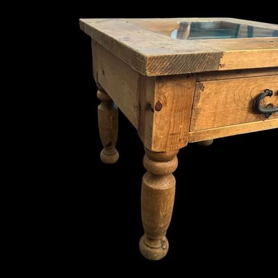Sale Photo Thumbnail #920: 21"T × 24"W × 24"D Rustic solid wood end table featuring inset glass top pane  single storage drawer with dark iron drop ring pull  and thick turned baluster legs. Dimensions: 21" Tall x 24" Wide x 24" Deep.  
