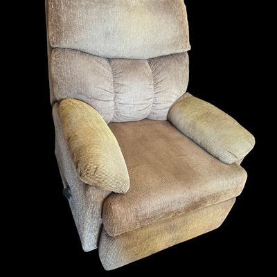 Sale Photo Thumbnail #946: Very clean overstuffed stationary recliner chair upholstered in ribbed tan/taupe corduroy fabric featuring plush pillow-top armrests  segmented back support  and side lever extendable footrest.  