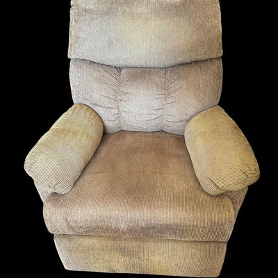 Sale Photo Thumbnail #945: Very clean overstuffed stationary recliner chair upholstered in ribbed tan/taupe corduroy fabric featuring plush pillow-top armrests  segmented back support  and side lever extendable footrest.  