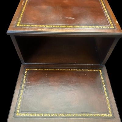 Sale Photo Thumbnail #959: 25.50 x 17.75 x 29.00 Traditional two-tier step-down end table featuring gold-embossed leather top surfaces  open middle cubby bay  lower drawer with brass swan-neck pull handle  and dovetail joinery 25.50 x 17.75 x 29.00  