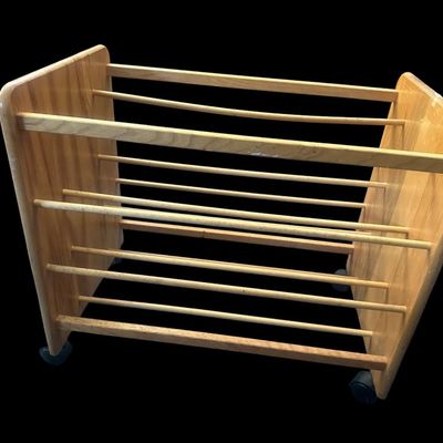 Sale Photo Thumbnail #972: 24"T × 28"L × 17.5"W Solid light wood mobile caddy featuring multi-tiered horizontal wooden dowel racks  solid end panels  and swivel caster wheels. Dimensions: 24" Tall x 28" Long x 17.50" Wide.  