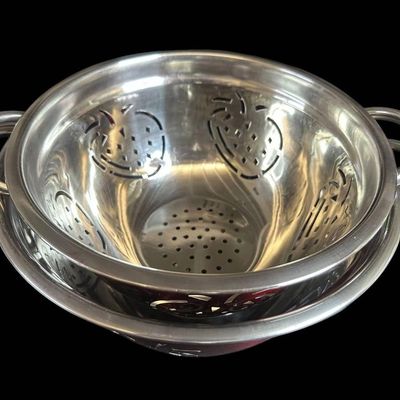 Sale Photo Thumbnail #991:  Two Stainless Steel Colanders with Red Exterior and Apple Cutout Design.                           