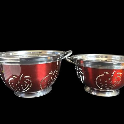 Sale Photo Thumbnail #985:  Two Stainless Steel Colanders with Red Exterior and Apple Cutout Design.                           