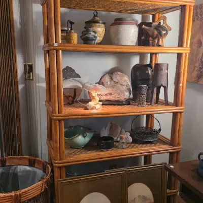 Sale Photo Thumbnail #7: Vintage bamboo and rattan five-tier étagère shelving unit, displaying an assortment of pottery, art objects, and framed landscape prints.