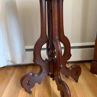 Antique Victorian walnut oval marble top table.