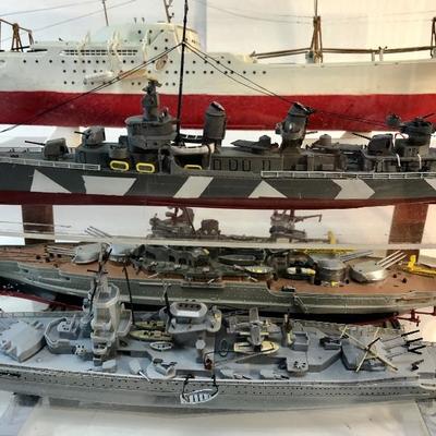 4 completed ship models inside of a customized aquarium 