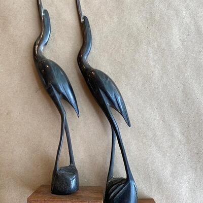 Pair of carved horn on wood base birds