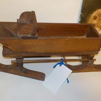 Hand crafted wooden doll sled and primate picture.