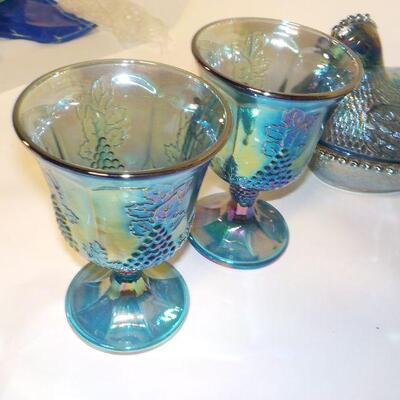 Vintage Blue Carnival Glass  blue iridescent carnival glass: footed candy dish with lid, two goblets, oval footed bowl with fruit on...