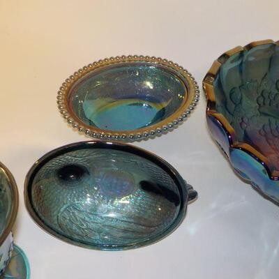 Vintage Blue Carnival Glass  blue iridescent carnival glass: footed candy dish with lid, two goblets, oval footed bowl with fruit on...