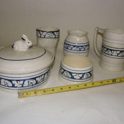 Lot of Dedham Pottery: Lot of five Dedham Pottery pieces: Covered round baking dish; straight-sided pitcher; rounded pitcher; boot-shape...