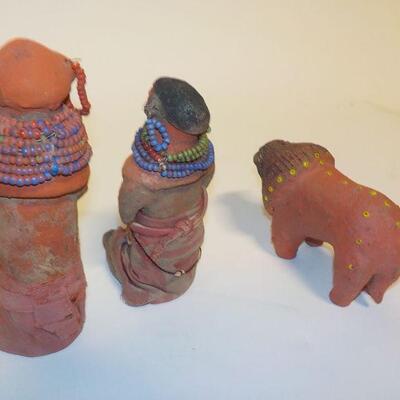 3 Antique handcrafted dolls and lion.