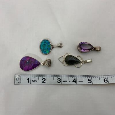 .69. Four Sterling Pendants | Various Stones