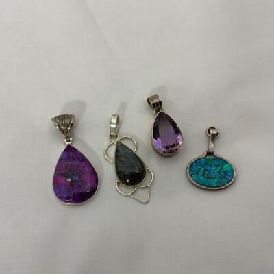 .69. Four Sterling Pendants | Various Stones